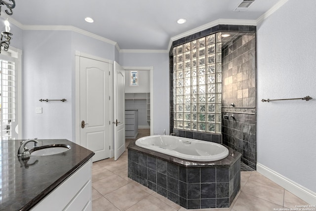 bathroom with visible vents, a healthy amount of sunlight, tile patterned flooring, and a garden tub