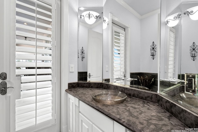 bathroom with vanity and ornamental molding