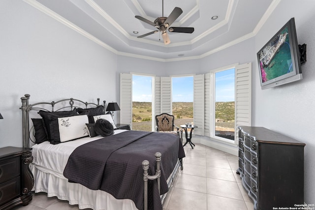 bedroom featuring light tile patterned flooring, crown molding, a ceiling fan, and a raised ceiling