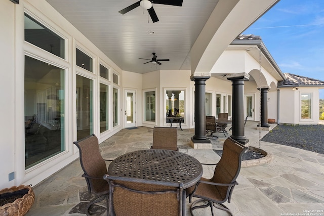 view of patio with outdoor dining space and ceiling fan