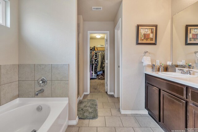 8926 Double Oak, San Antonio, TX 78254 - full bath with a bath, vanity, a spacious closet, visible vents, and tile patterned floors