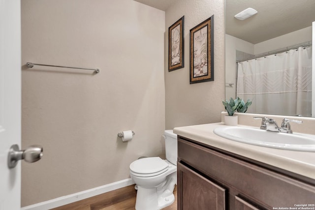 8926 Double Oak, San Antonio, TX 78254 - full bath with baseboards, curtained shower, toilet, vanity, and wood finished floors