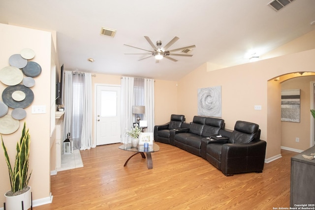 8418 Hera, Universal City, TX 78148 - living room featuring visible vents, arched walkways, a ceiling fan, light wood finished floors, and vaulted ceiling