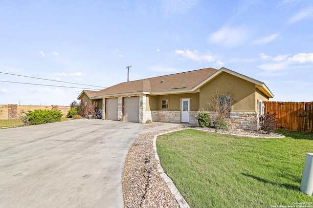 single story home with stucco siding, stone siding, a front lawn, a garage, and fence