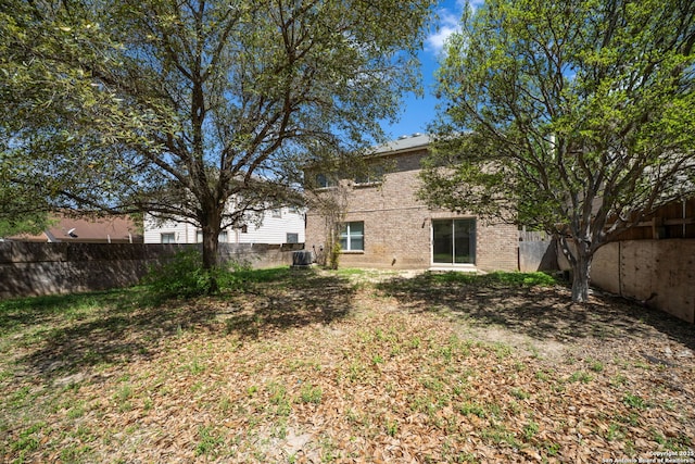 view of yard featuring central AC unit and fence