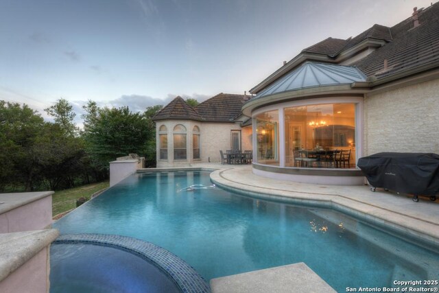 25204 Wentworth, San Antonio, TX 78260 - view of swimming pool featuring area for grilling, a patio area, outdoor dining area, and a pool with connected hot tub