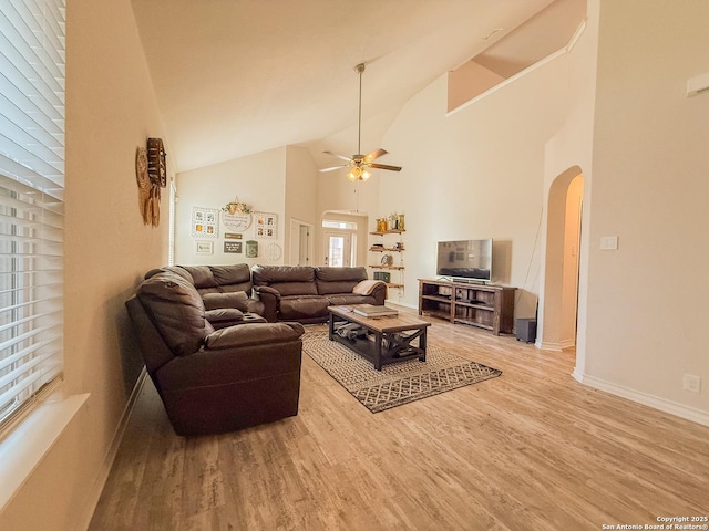 13511 Pickett, San Antonio, TX 78254 - living area with high vaulted ceiling, arched walkways, light wood-type flooring, a ceiling fan, and baseboards