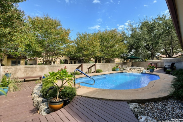 view of pool featuring a fenced backyard, a fenced in pool, and a deck