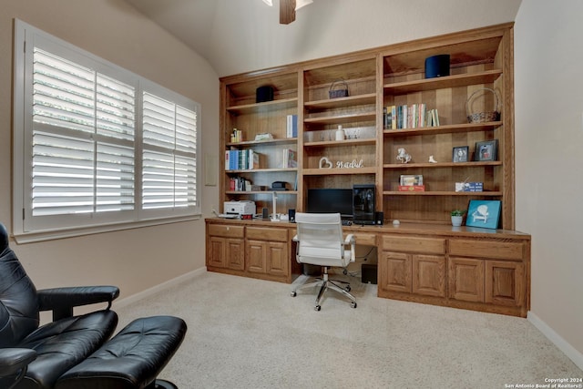 carpeted home office featuring built in desk, baseboards, and a ceiling fan