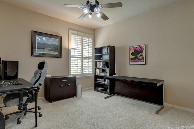 office area with baseboards, a ceiling fan, and light colored carpet