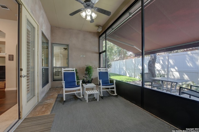 sunroom / solarium featuring ceiling fan and visible vents