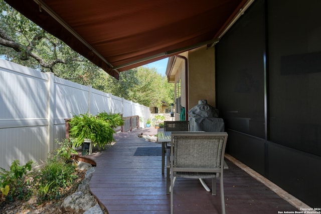 wooden terrace with outdoor dining space and fence private yard