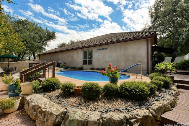 outdoor pool featuring a wooden deck