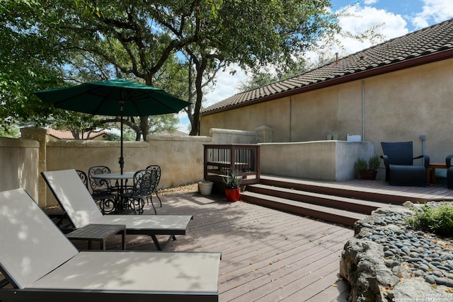 wooden terrace with outdoor dining area