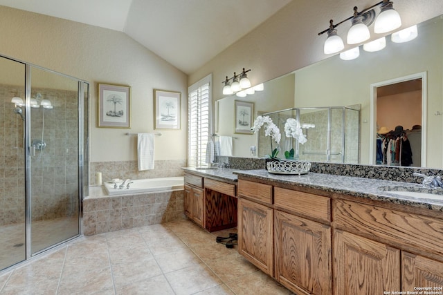 bathroom with a shower stall, tile patterned flooring, a garden tub, and a sink
