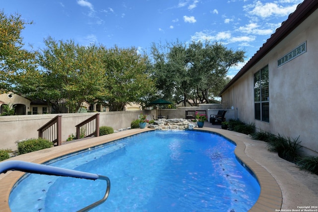 view of swimming pool featuring a fenced in pool and a fenced backyard