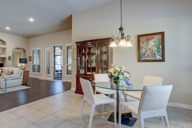 dining space with baseboards, recessed lighting, an inviting chandelier, and light tile patterned flooring
