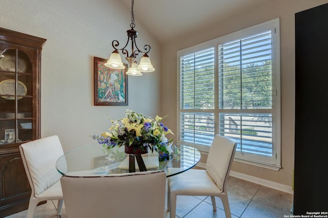 dining room featuring a chandelier, baseboards, vaulted ceiling, and light tile patterned flooring