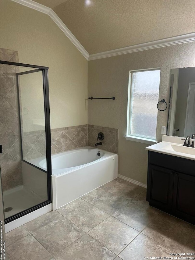 full bathroom with vanity, ornamental molding, a stall shower, lofted ceiling, and a garden tub