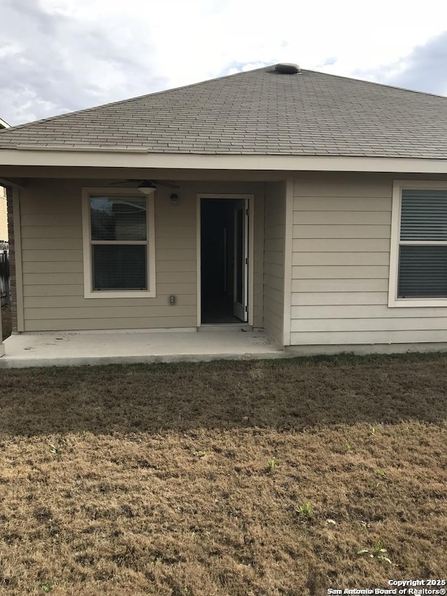 rear view of house featuring a patio area and a lawn