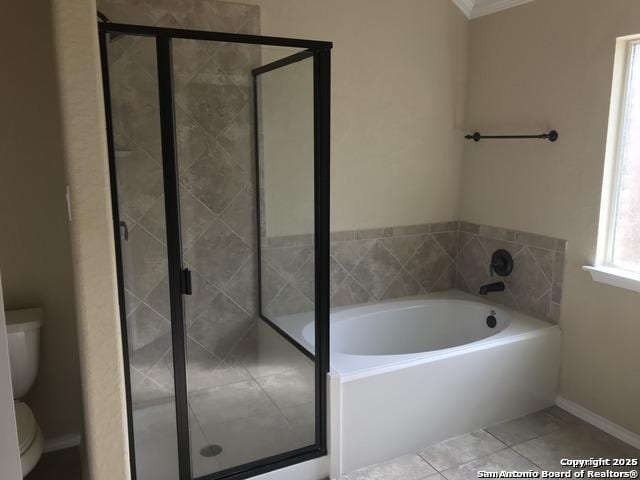 full bathroom with a stall shower, ornamental molding, a garden tub, and toilet