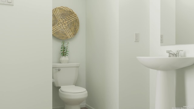 half bathroom featuring toilet
