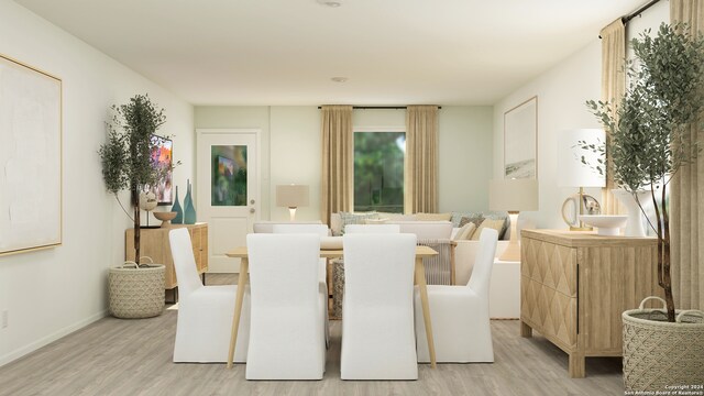 dining area featuring light wood-style flooring and baseboards