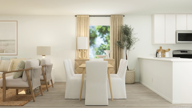 dining room featuring light wood-style floors and baseboards