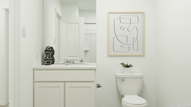 bathroom featuring toilet and vanity