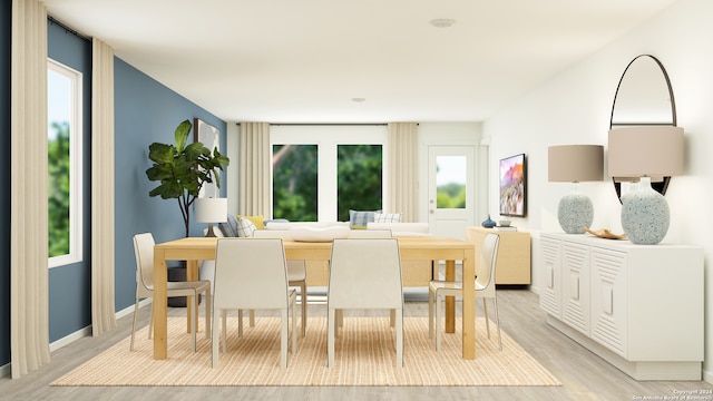 dining area featuring baseboards and light wood-style floors
