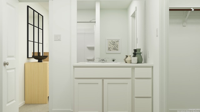 bathroom with a spacious closet and vanity