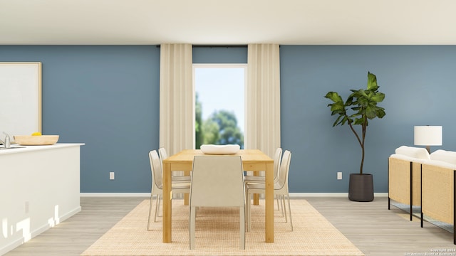dining room featuring light wood-type flooring and baseboards