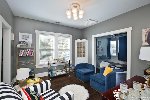 636 W Hollywood Ave, San Antonio, TX 78212 - living area with visible vents, baseboards, ceiling fan with notable chandelier, and wood finished floors
