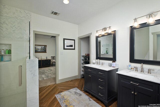 636 W Hollywood Ave, San Antonio, TX 78212 - full bathroom featuring two vanities, tiled shower, visible vents, and a sink