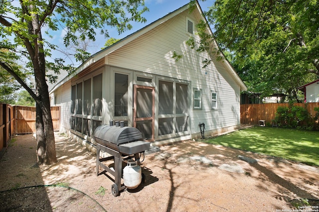 636 W Hollywood Ave, San Antonio, TX 78212 - rear view of property featuring a sunroom, a yard, a fenced backyard, and a patio area