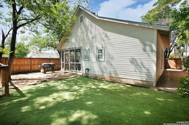 636 W Hollywood Ave, San Antonio, TX 78212 - rear view of property featuring a patio, a fenced backyard, and a lawn
