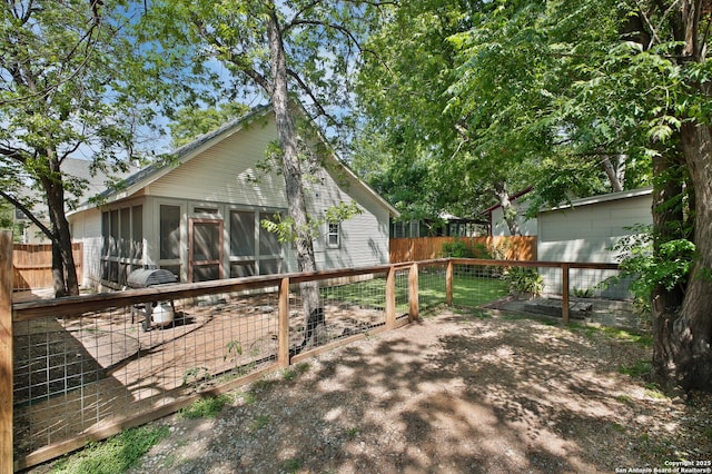 636 W Hollywood Ave, San Antonio, TX 78212 - rear view of house with a sunroom and fence