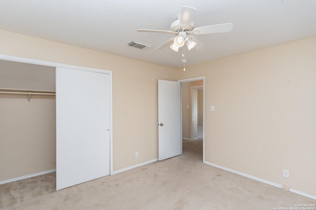 unfurnished bedroom with visible vents, baseboards, a closet, and carpet floors