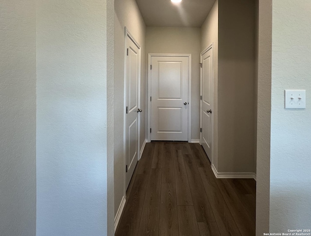 13750 Birch Xing, San Antonio, TX 78252 - corridor featuring baseboards, a textured wall, and dark wood finished floors