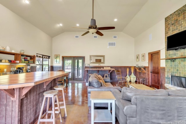 723 Tierra Linda, Concan, TX 78838 - living area with french doors, ceiling fan, visible vents, and a wainscoted wall