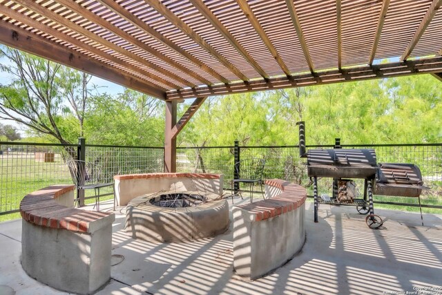 723 Tierra Linda, Concan, TX 78838 - view of patio featuring an outdoor fire pit and fence