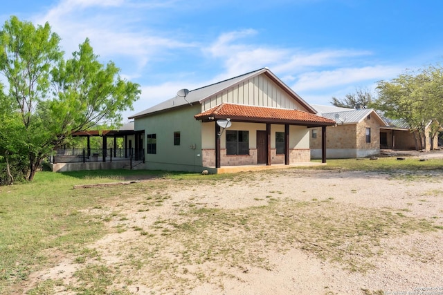 723 Tierra Linda, Concan, TX 78838 - back of property with board and batten siding and a tile roof