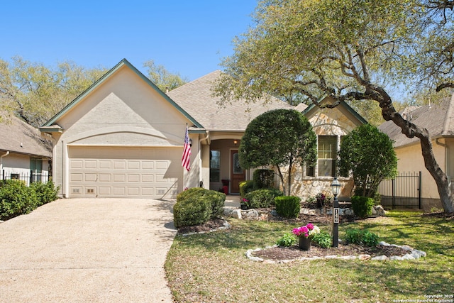 single story home featuring an attached garage, concrete driveway, fence, and a front lawn