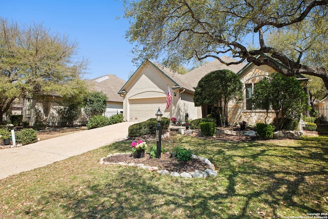 view of front of property featuring a front yard, stone siding, a garage, concrete driveway, and stucco siding
