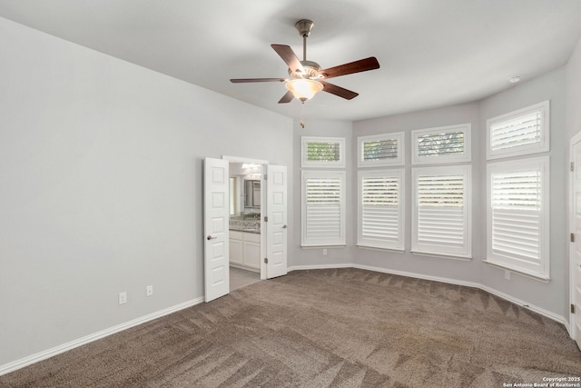 unfurnished bedroom with baseboards, multiple windows, and carpet