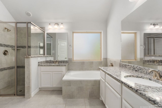 bathroom with a sink, a bath, a shower stall, and tile patterned flooring
