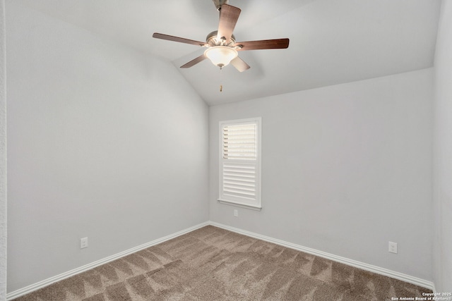 empty room with lofted ceiling, ceiling fan, baseboards, and carpet floors