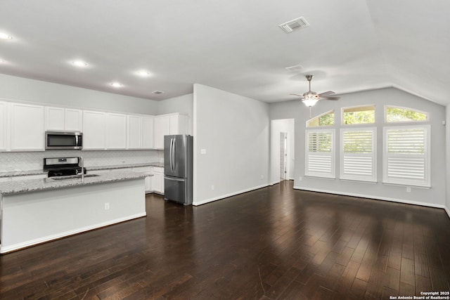 kitchen featuring ceiling fan, tasteful backsplash, visible vents, light stone counters, and stainless steel appliances