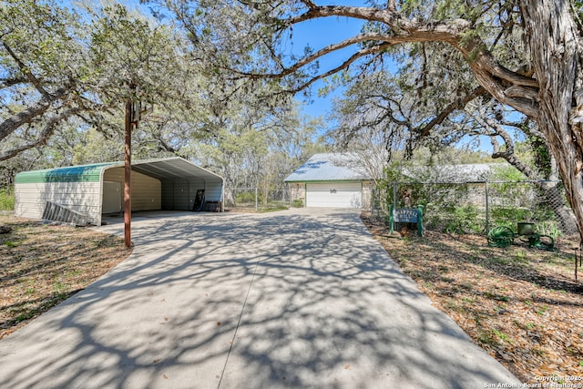 21440 Fm 306, Canyon Lake, TX 78133 - view of property exterior with a carport, fence, an outdoor structure, and driveway