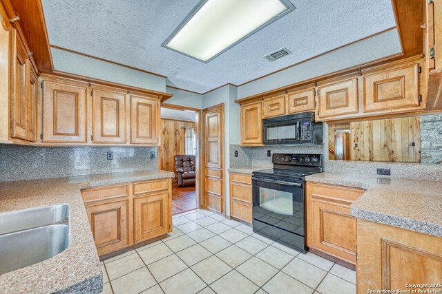21440 Fm 306, Canyon Lake, TX 78133 - kitchen with light countertops, a textured ceiling, light tile patterned flooring, decorative backsplash, and black appliances